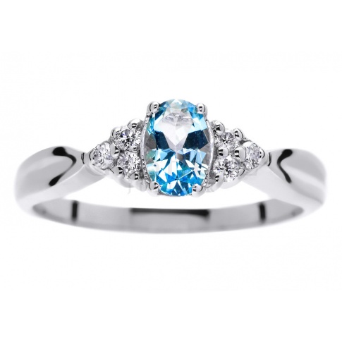 Pełen błękitu pierścionek z białego kruszcu z owalnym topazem blue i brylantami 0.09 ct