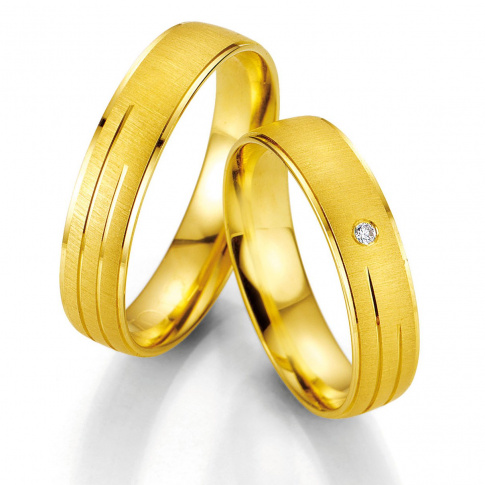 Zachwycające obrączki ślubne z żółtego złota z brylantem 0,015 ct