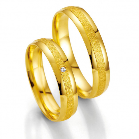 Ponadczasowe obrączki ślubne z żółtego złota z brylantem firmy Breuning